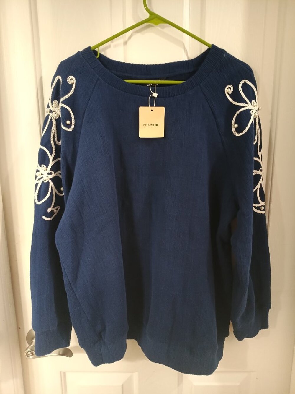 Bloomchic, navy blue with white trim detailing and pearl detail